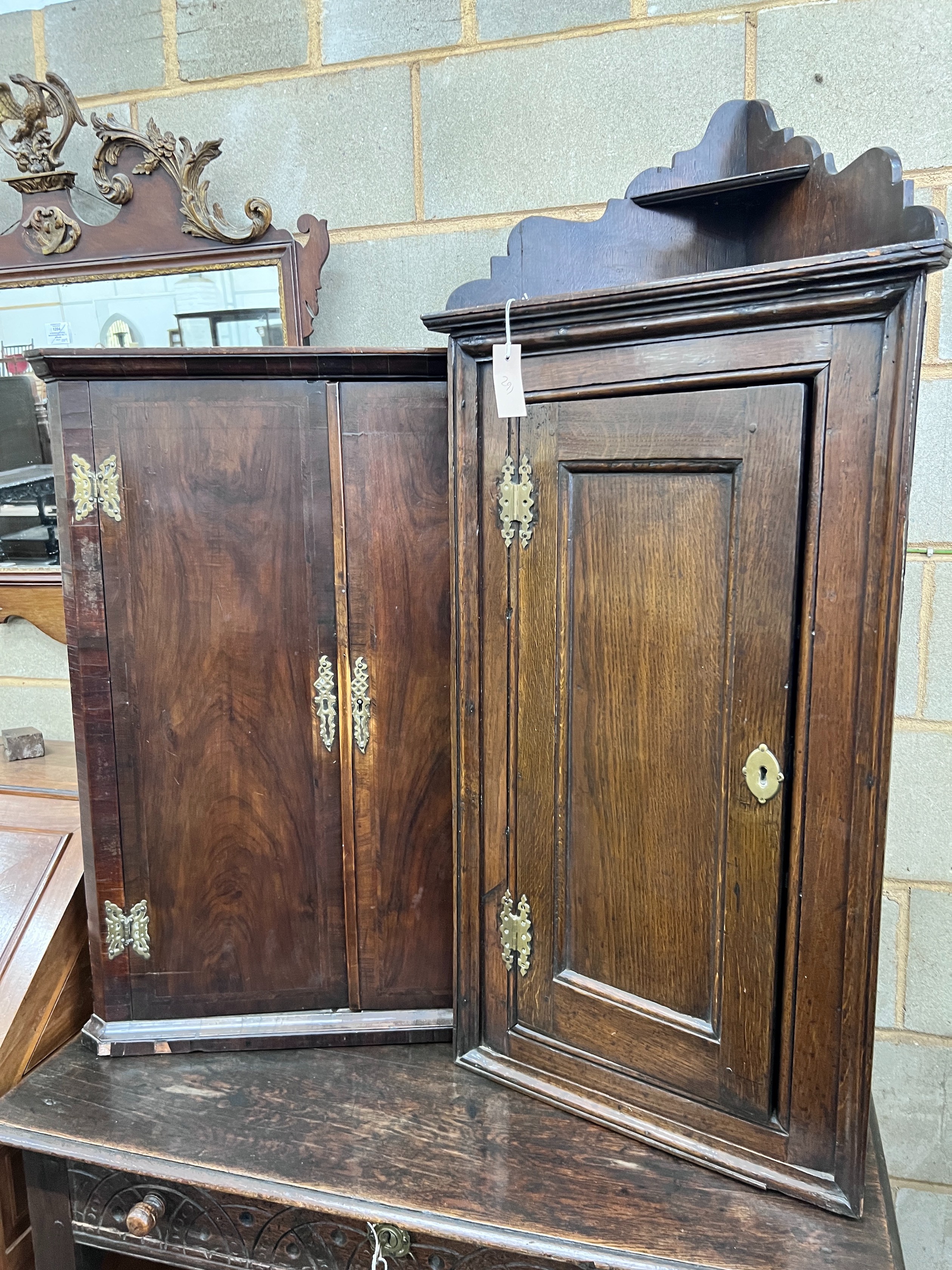 Two 18th century style hanging corner cupboards, one in oak, the other walnut, width 52cm and 70cm *Please note the sale commences at 9am.